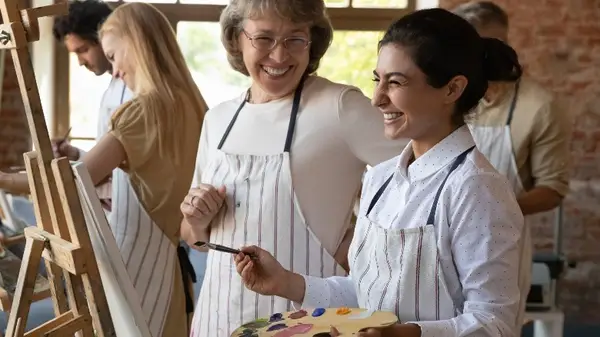Woman painting with teacher