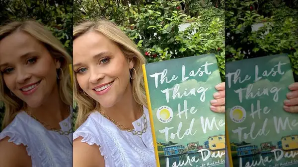 Reese Witherspoon taking a selfie while holding 