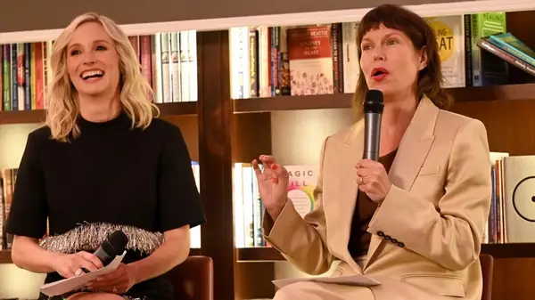 Candice King laughing while sitting in front of a bookshelf with author E. Lockhart
