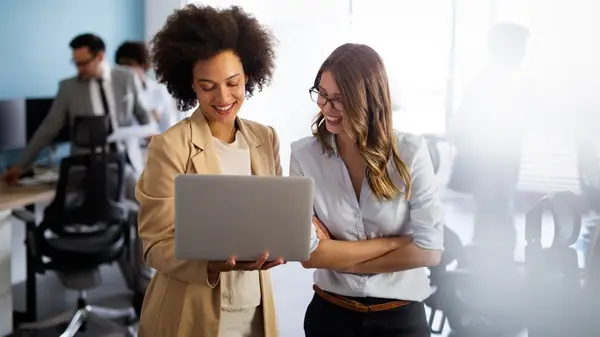 Two colleagues smiling at work