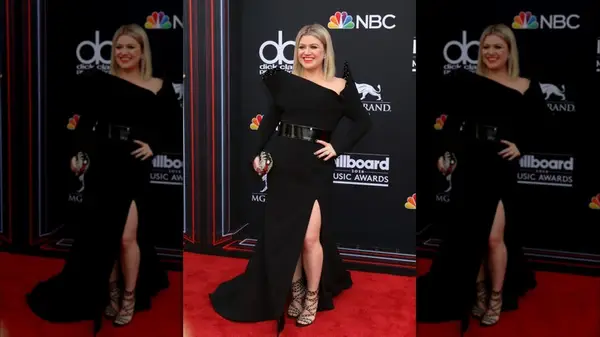 Kelly Clarkson on the red carpet in a black asymmetrical gown