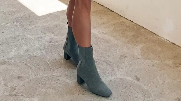 A woman wearing gray sock boots