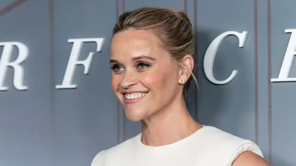 Reese Witherspoon on the red carpet in a white dres