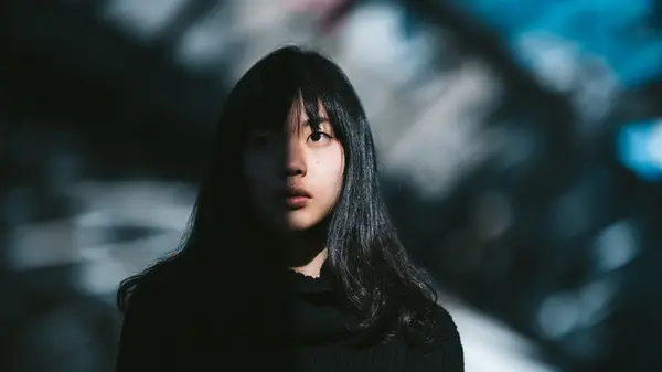 Woman half in darkness