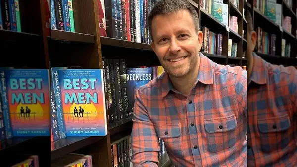 Sidney Karger posing with his book