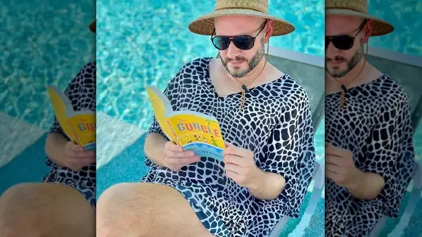 Steven Rowley reading his book by the pool