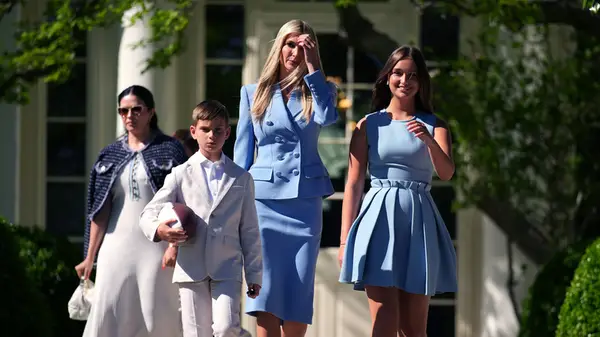Ivanka Trump walking with her daughter and son in front of the White House
