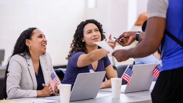 Women volunteering as poll workers