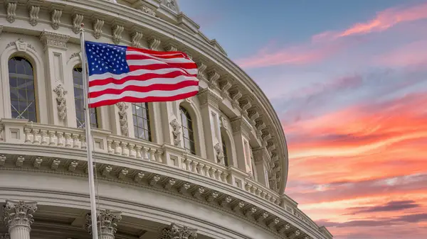 An American Flag flies outside the Capitol building in Washington D.C.