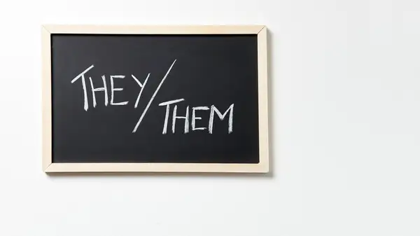 A board with they/them written on it