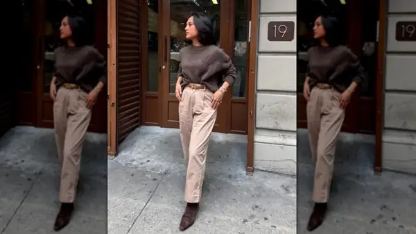 A woman standing on the sidewalk in a monochromatic brown outfit