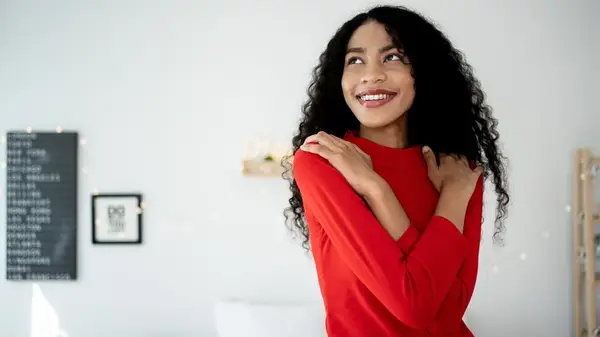 young woman embracing herself