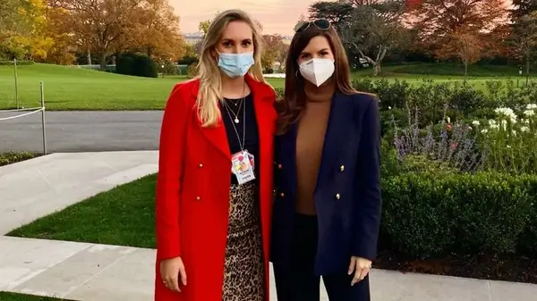 Kaitlan Collins wearing a mask while posing with Meridith McGraw