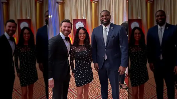 Lauren Boebert and Byron Donalds smiling with a fan at the NRCC President