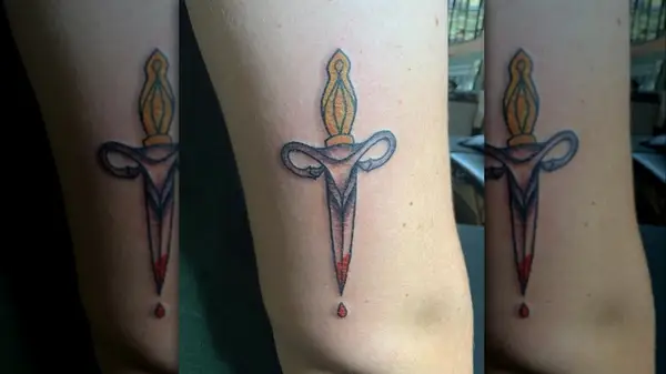 A uterus dagger tattoo
