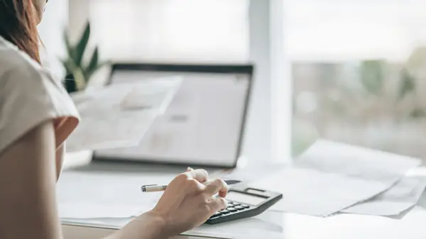 Woman uses calculator