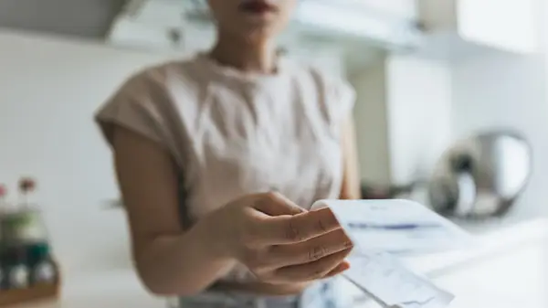 Woman looks at bills