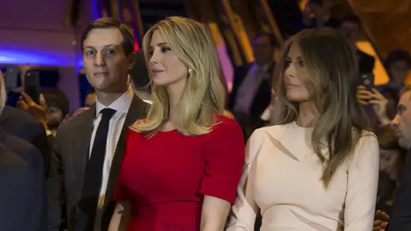 Melania and Ivanka Trump standing next to each other with Jared Kushner in the background