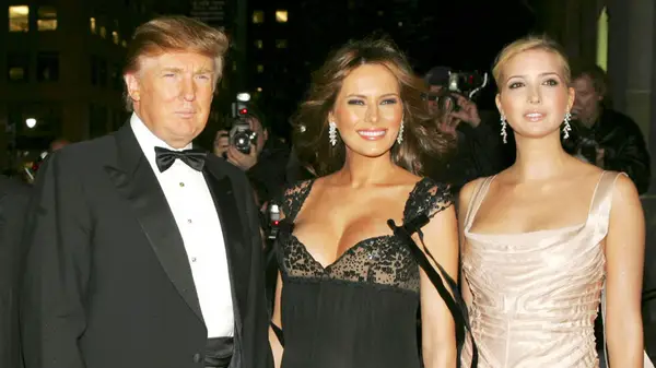 Donald Trump standing next to Melania and Ivanka in formal attire