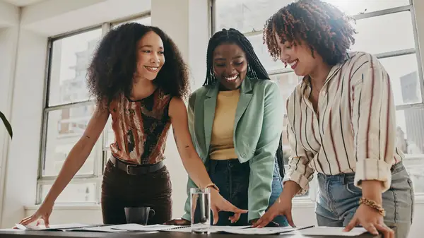 Three woman work together in the office