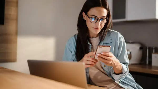 Woman incredulously looks at phone