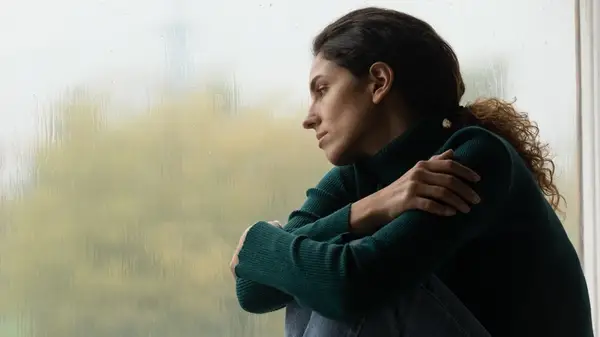 Woman smiles holding cellphone
