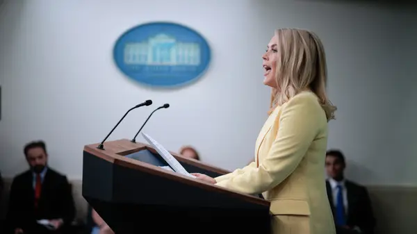 Karoline Leavitt standing at a podium