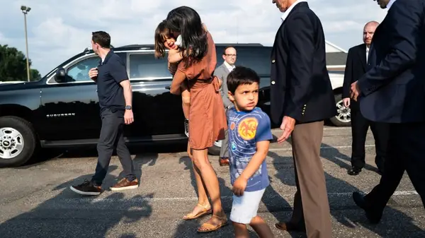 Usha Vance with her kids wearing a dress and sandals