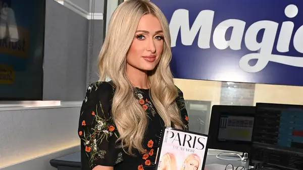 Paris Hilton holding her book