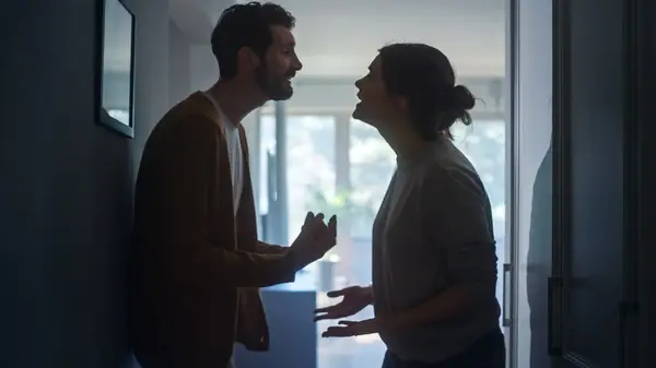 Couple fighting in hallway