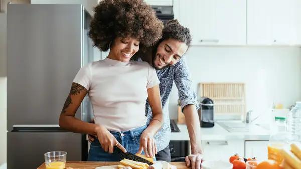 couple making charcuterie board