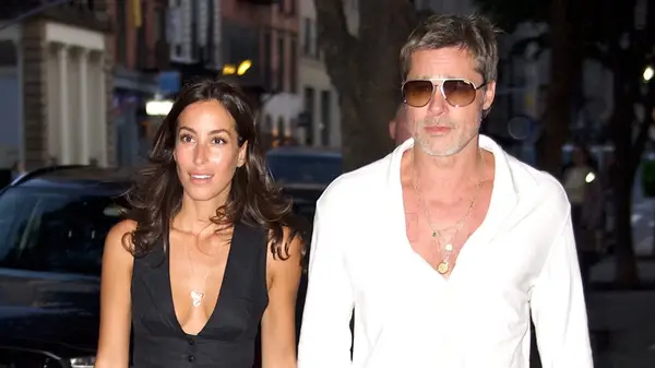 Ines de Ramon and Brad Pitt walking together