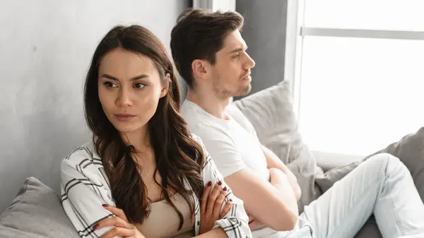 An unhappy couple on the sofa 