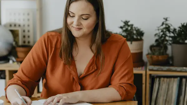 A woman writing in her journal 
