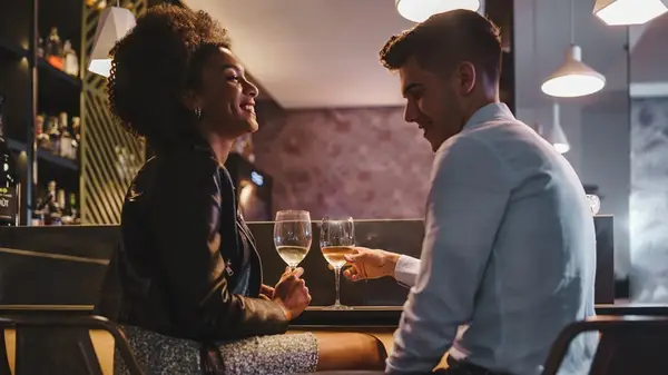 Couple talking, drinking wine