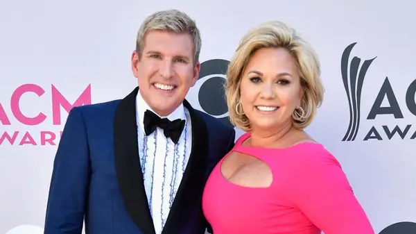 Julie Chrisley and Todd Chrisley posing on the red carpet