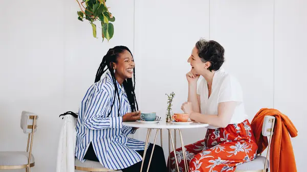 two women chatting over coffee