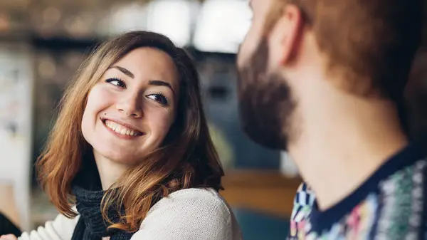 woman looking happily at a man