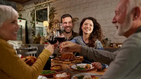 four people share a toast