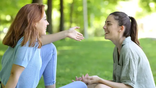 Two women talking outside 