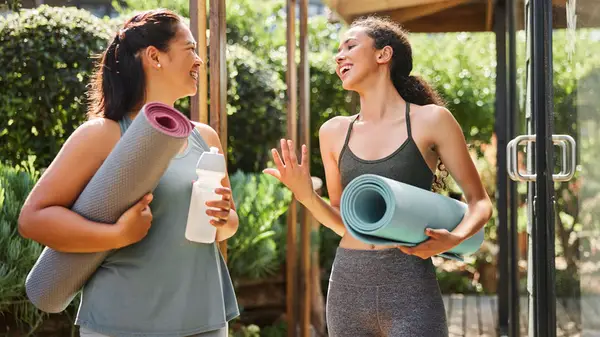 Women with yoga mats