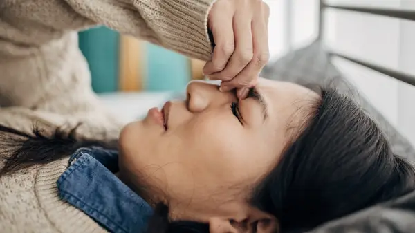 Woman pinching eyebrows