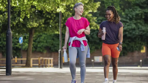 two people walking laughing
