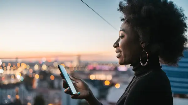 woman on balcony looking at phone