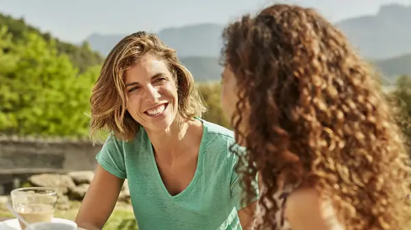 two women talking outside 