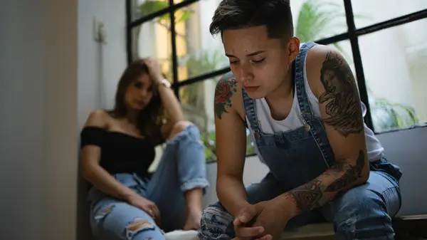 Couple stands in hallway arguing