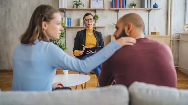Couple talking in front of therapist