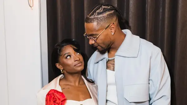 Simone Biles and Jonathan Owens looking at each other