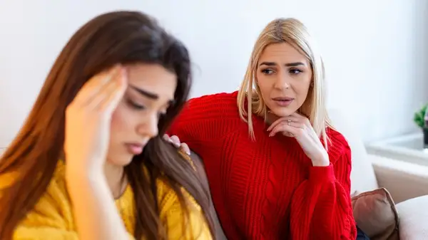 two girls having awkward discussion