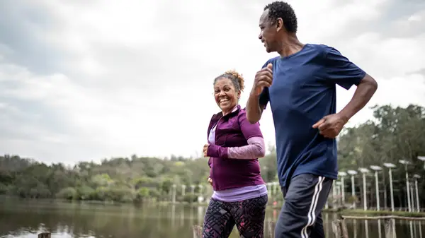 Couple jogs together in park